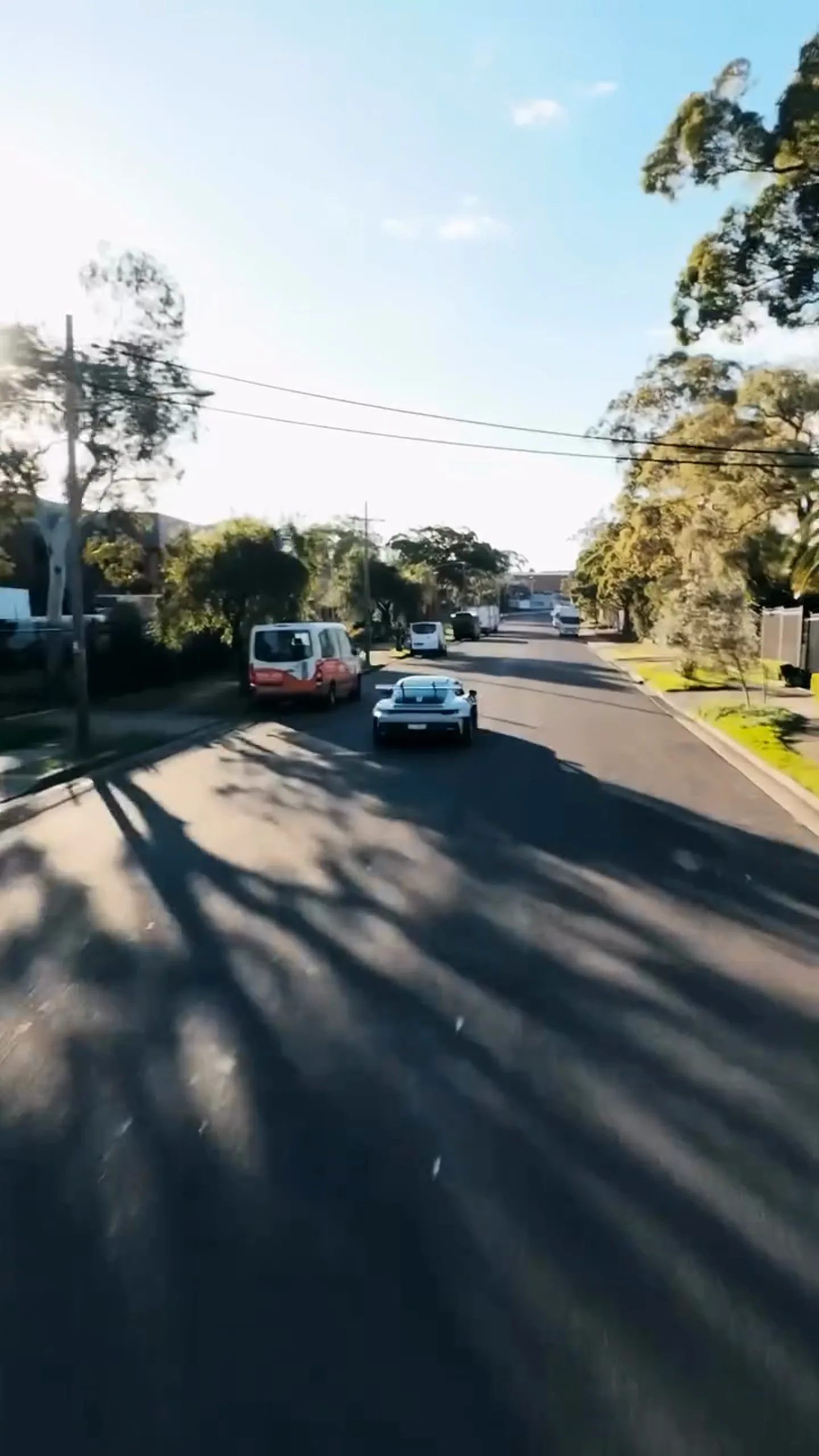 The Porsche 911 GT3 RS driving away after the swap, the day continuing