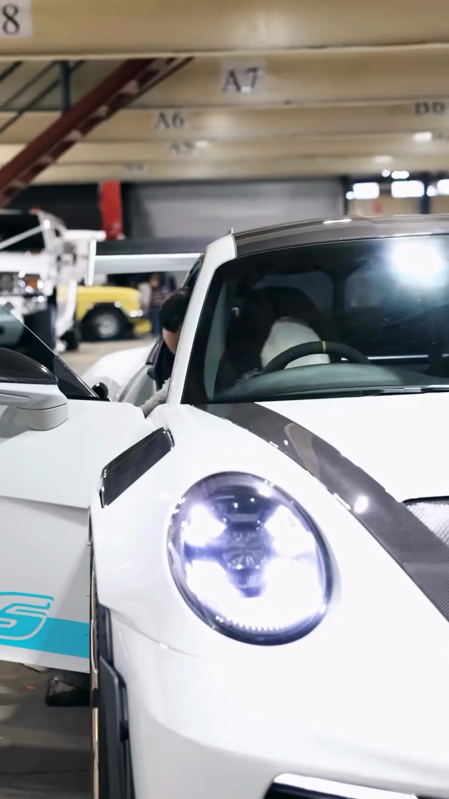 A Porsche 911 GT3 RS being loaded onto a trailer for delivery to a client